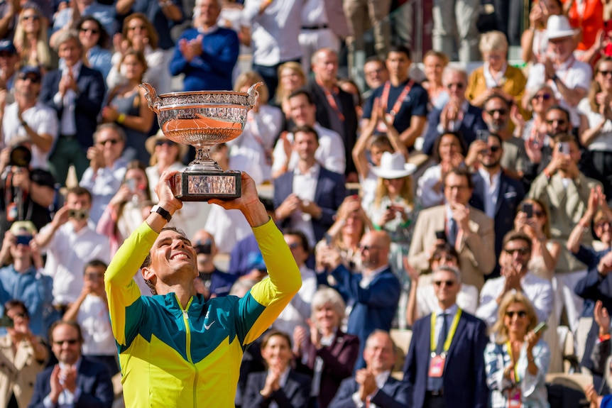 A smiling Rafael Nadal looks to the sky as he lifts the Coupe des Mousquetaires at Roland Garros.