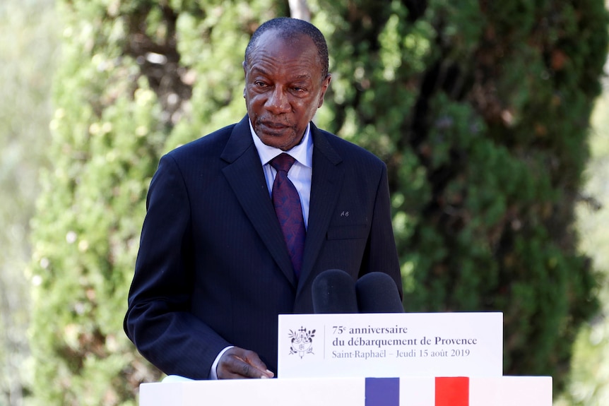 Guinean President Alpha Conde delivers a speech during a ceremony in France