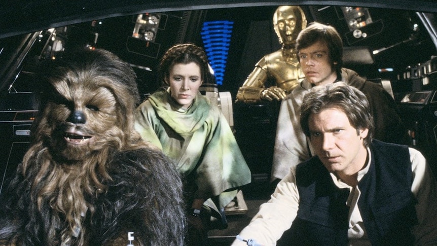 Chewbacca, Han Solo, C3PO, Luke Skywalker, and Princess Leia in the cockpit of the Millennium Falcon.
