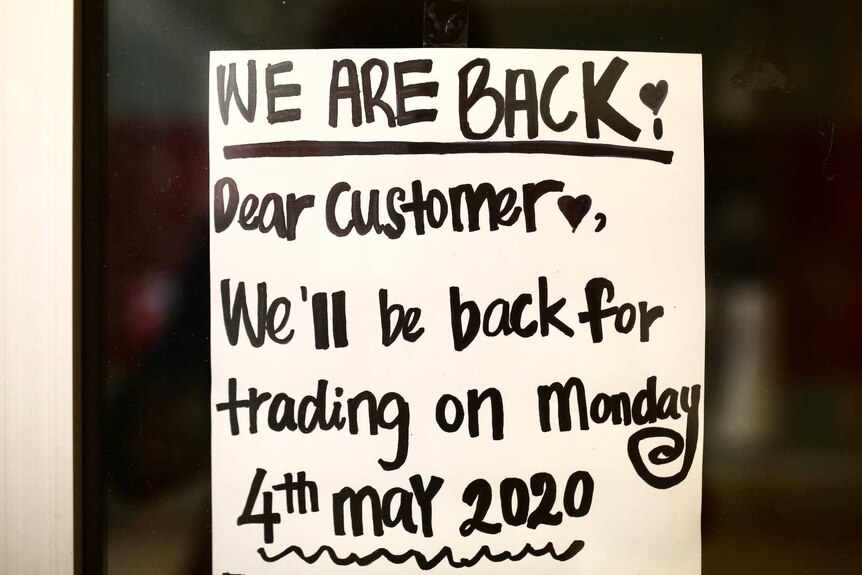 A handwritten sign taped to the front of a cafe in Trinity Arcade says it's reopening for takeaway.