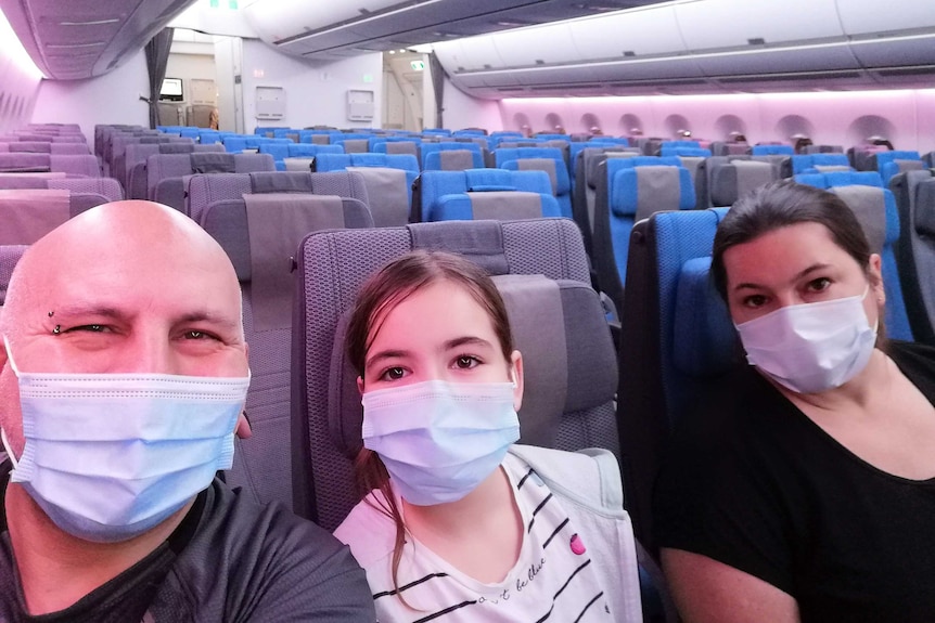 A family of three on a near empty flight.