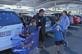 The Pirake family, with some kids in a trolley, at the end of a shopping trip