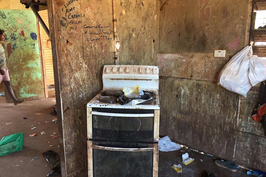 A graffitied kitchen in a house in minyerri