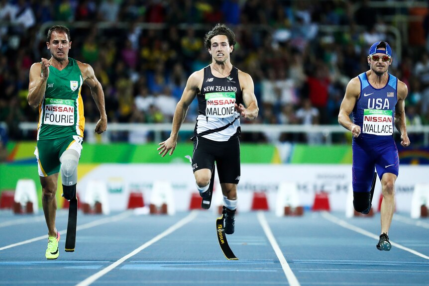 Three amputee sprinters at the Paralympics wearing flex feet race the men's 100m event.