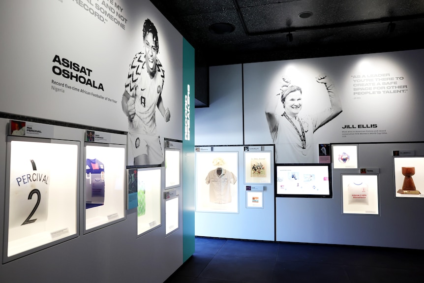 Glass cases containing objects from women's football in a temporary museum