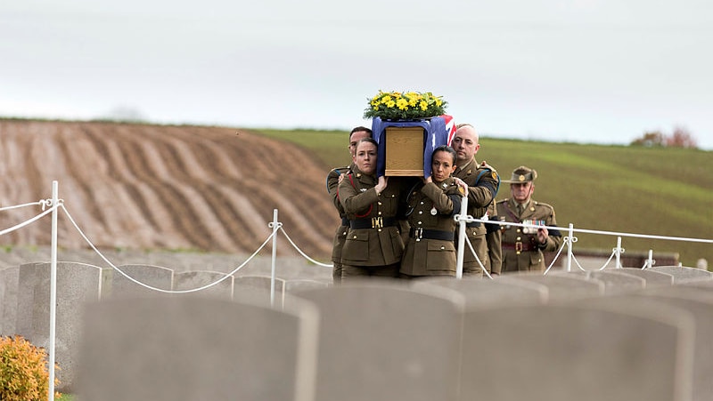 Soldiers carrying a coffin draped in an Australian flag