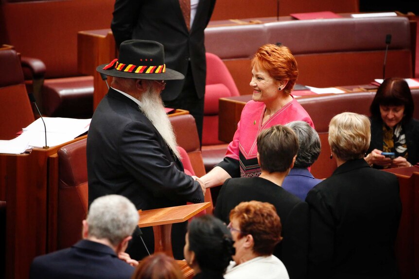 Labor Senator Pat Dodson shakes hands with One Nation Senator Pauline Hanson.