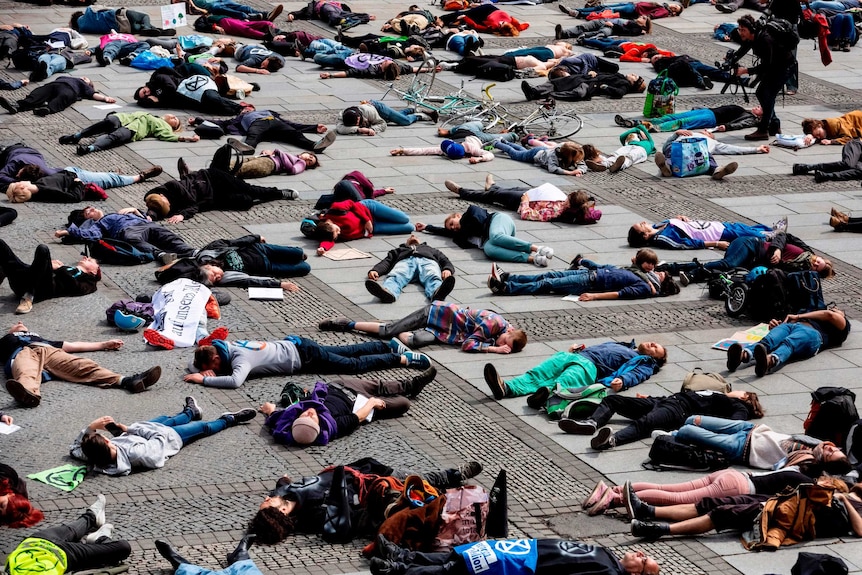 Climate change activists lie on the floor in a die-in protest in Berlin