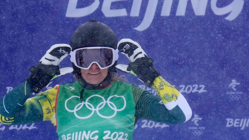A close-up pic of an Australian ski-cross competitor staring out through her goggles in the snow.