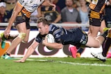 Michael Morgan dives in for the game-winning try against Brisbane