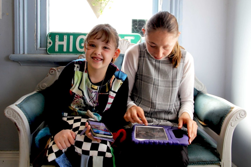 Lillian Whitehall sits on a couch at the hairdresser's smiling