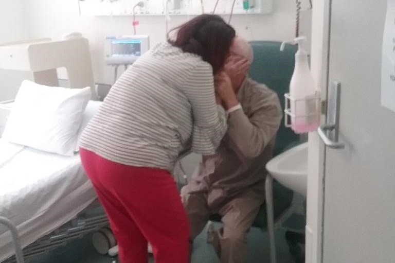 couple kissing in hospital room