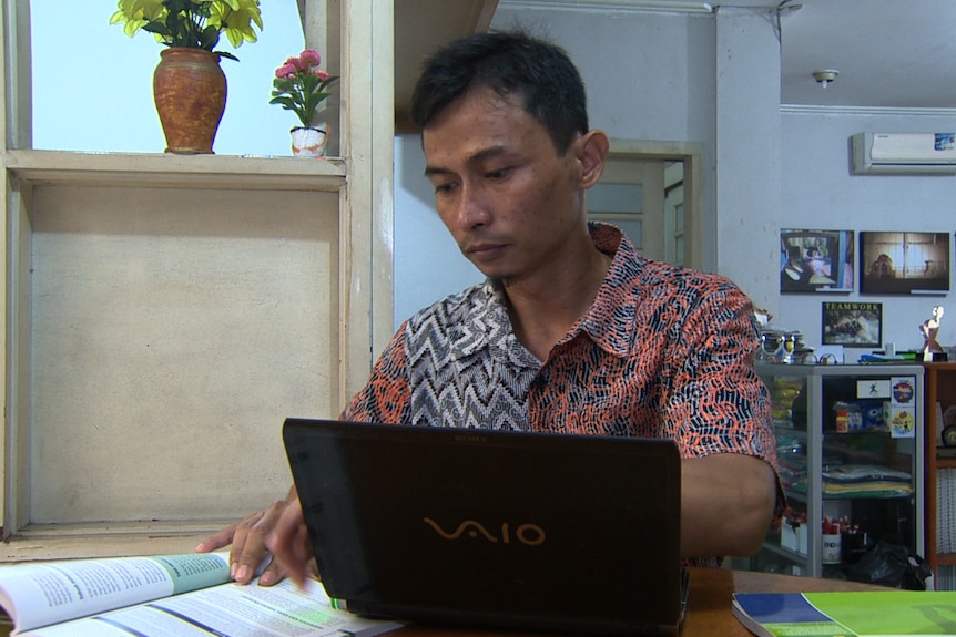 Andy Ardian reading over documents.