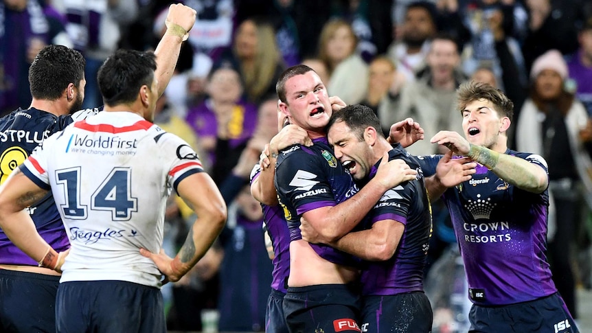 Cameron Smith hugs Joe Stimson after he scored a try for the Melbourne Storm.