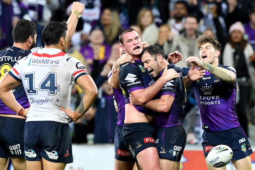 Cameron Smith hugs Joe Stimson after he scored a try for the Melbourne Storm.