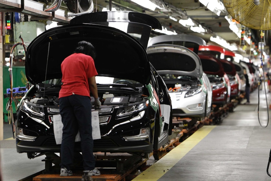 Assembly worker works on a Chevrolet car