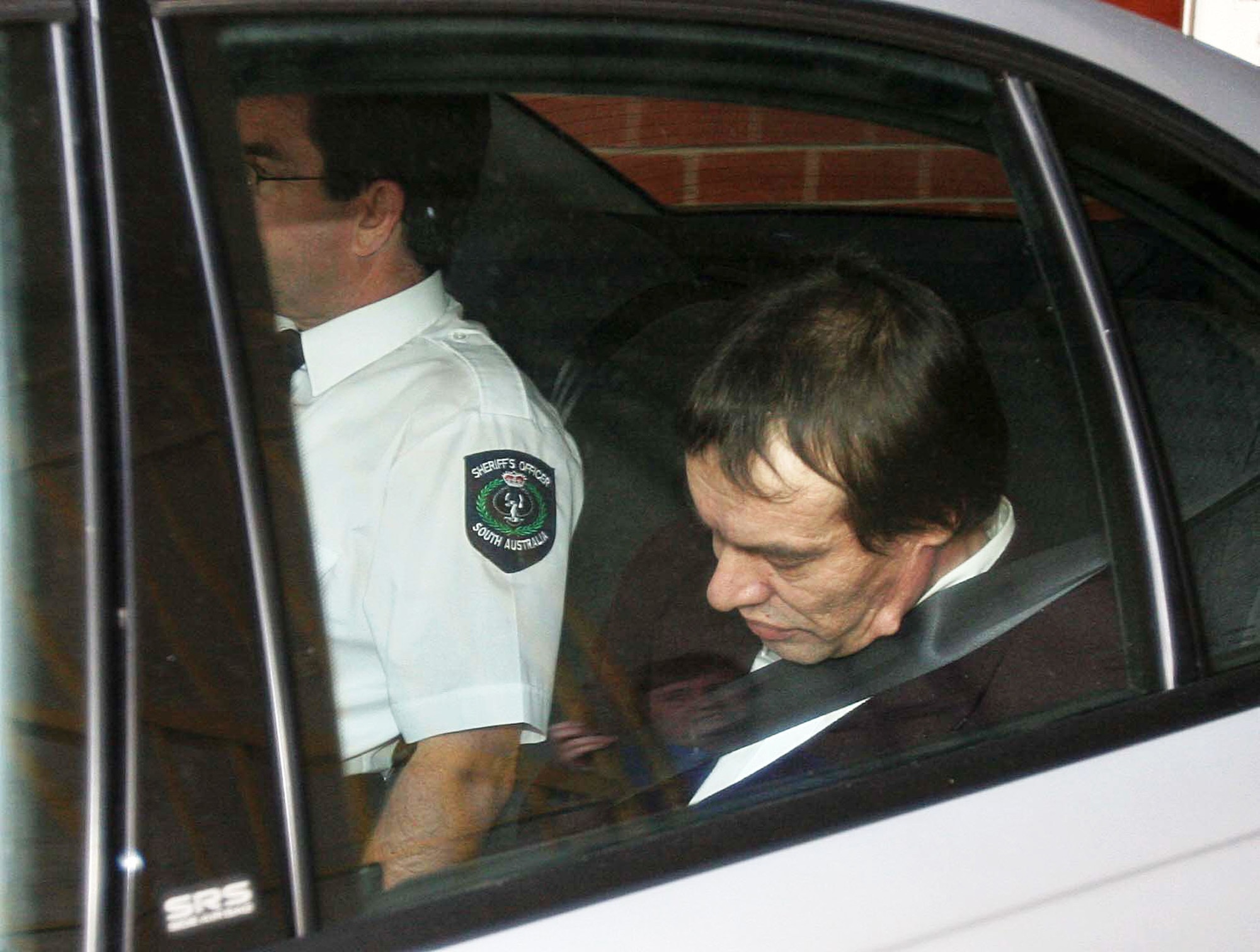 Snowtown accomplice Mark Ray Haydon in a car being escorted from court.