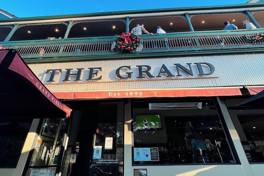 A shot looking up at the pub with a sign saying 'Grand Hotel'