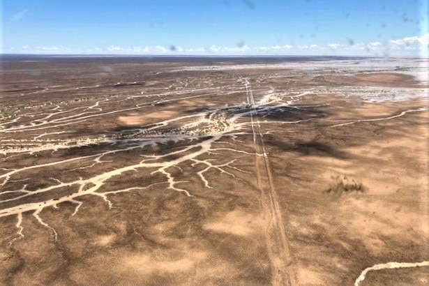 brown looking water makes its way through channels that filter through a brown, dry looking landscape 