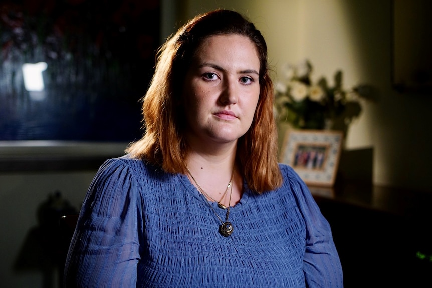 A woman wearing a blue top.