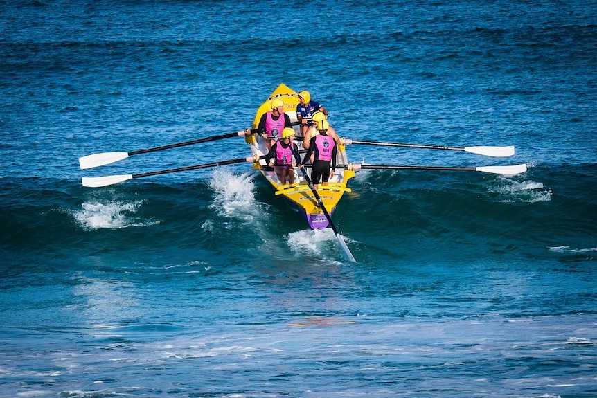 Surfboat crew on wave