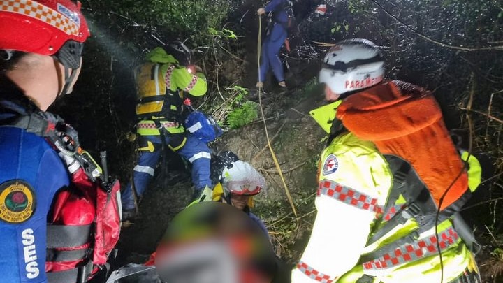 Emergency Services assisting the SES to rescue a person from flood waters