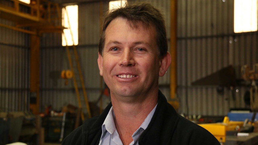 Portrait of James Haddin in his business's warehouse.