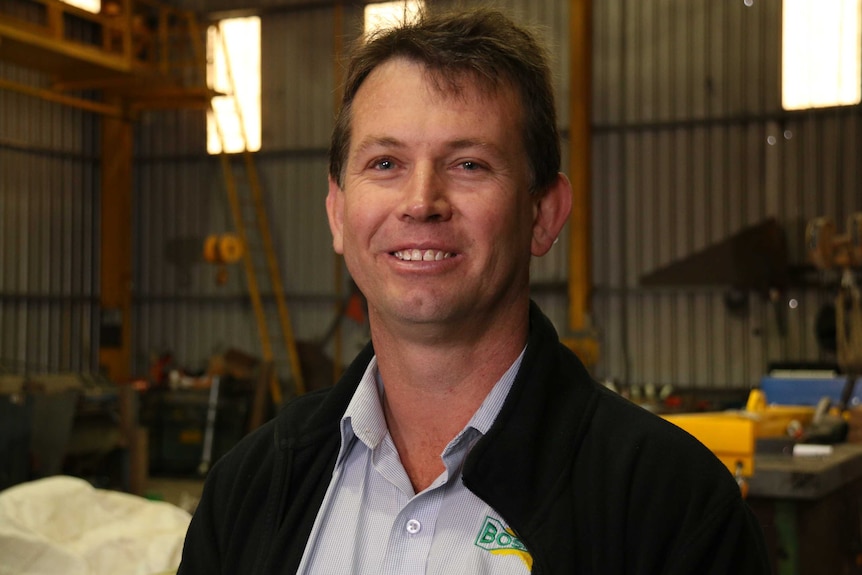 Portrait of James Haddin in his business's warehouse.