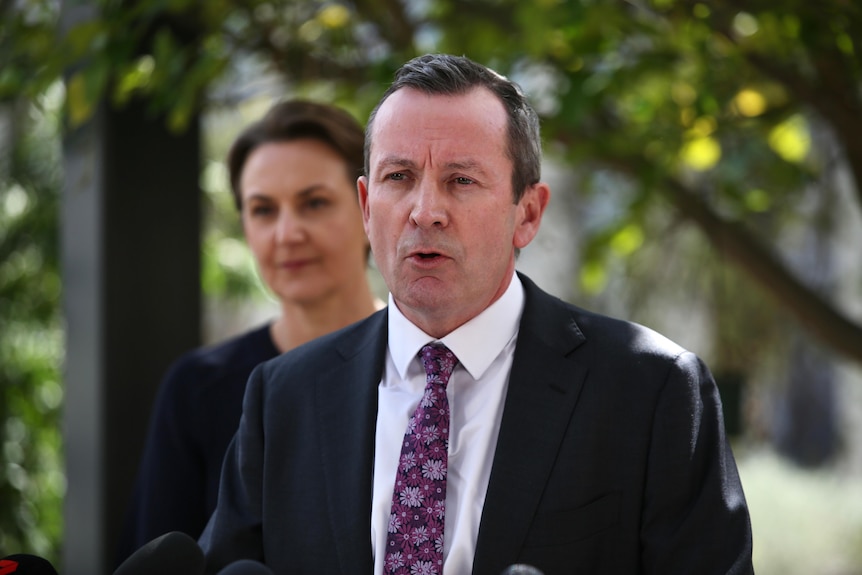 WA Premier Mark McGowan speaks at a press conference while wearing a suit. 