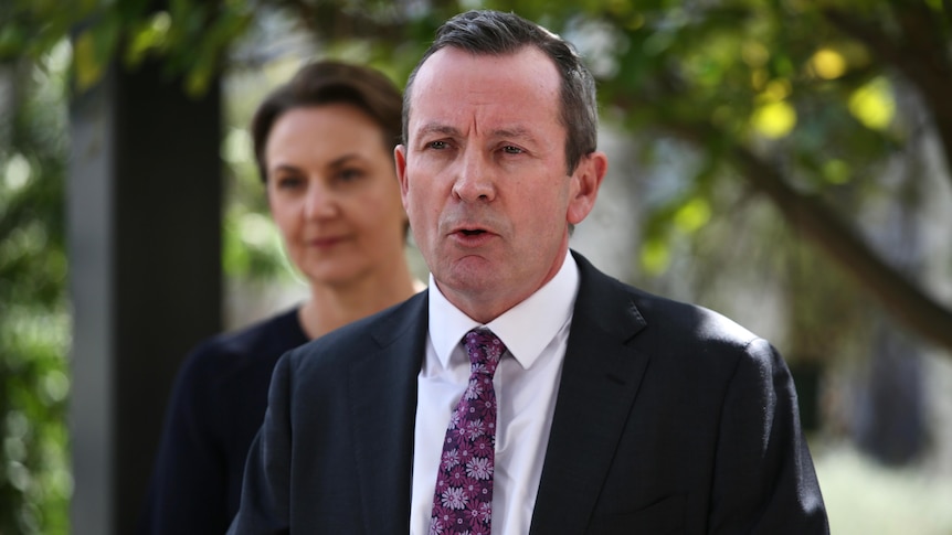 WA Premier Mark McGowan speaks at a press conference while wearing a suit. 