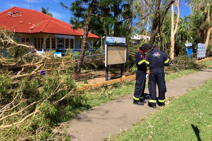 Search and rescue crews inspect a damaged property at Yeppoon