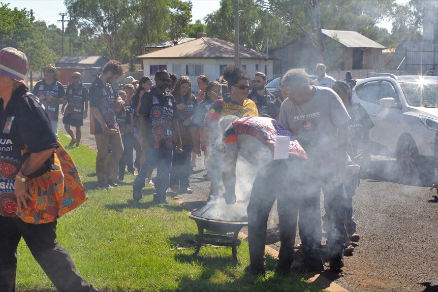 People line up for smoking ceremony.