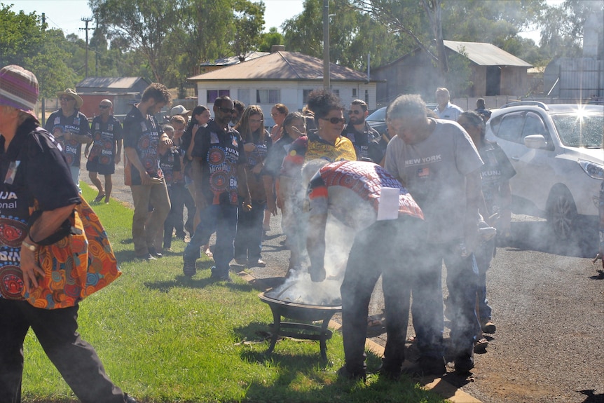 People line up for smoking ceremony.