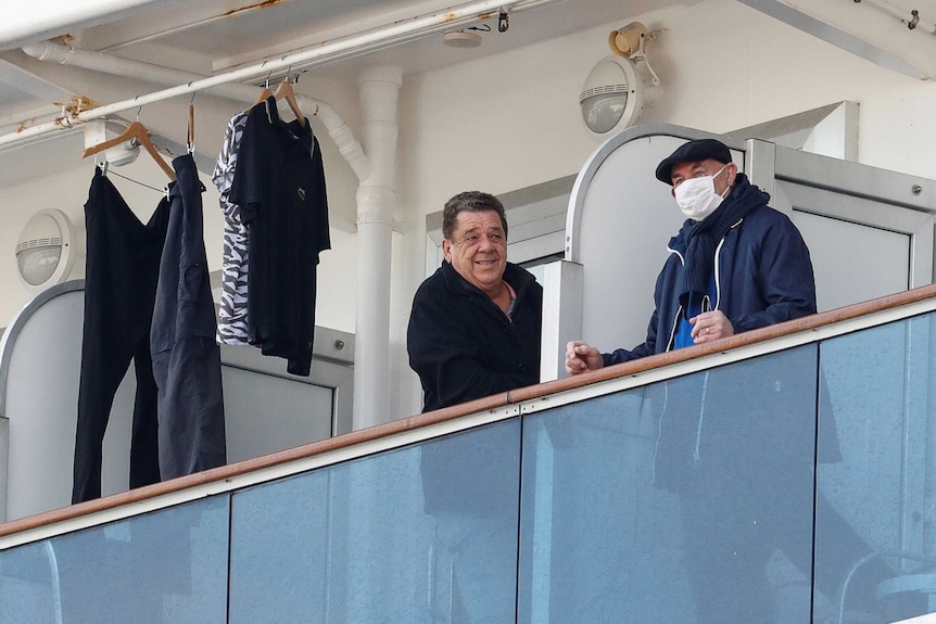 Two male passengers leaning on their railings on board the Diamond Princess