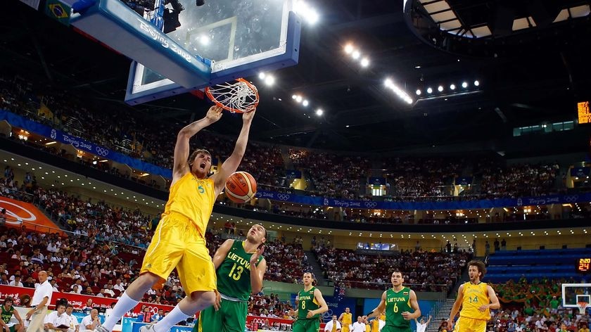 Boomers centre Andrew Bogut dunks over the defence of Lithuanian Sarunas Jasikevicius