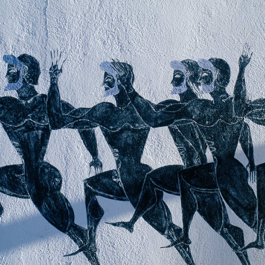 A black and white ancient mural depicts muscular black men with beards running in formation