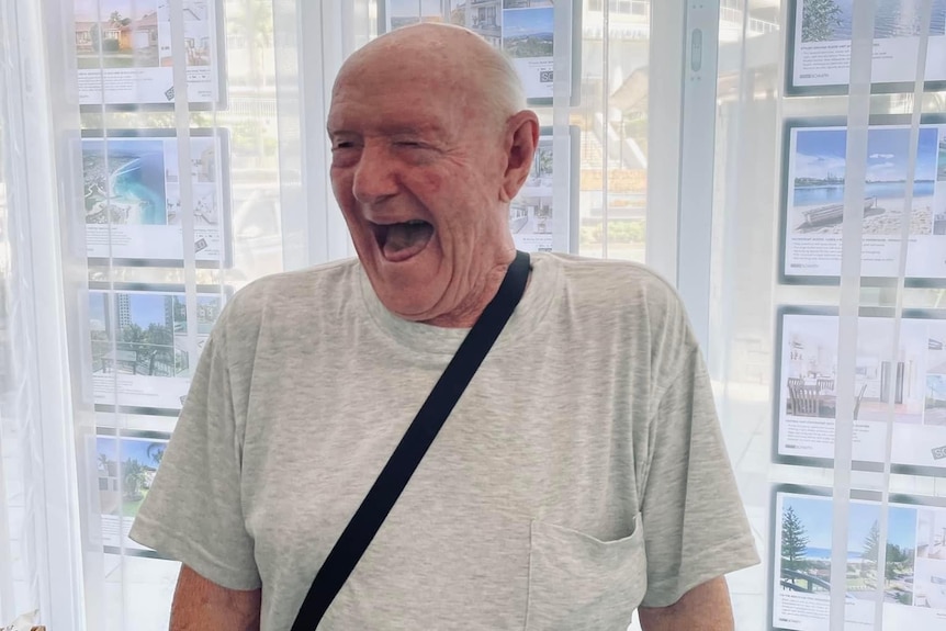 An elderly man smiling.