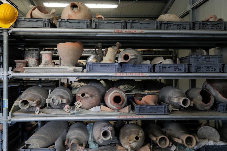 A collection of pottery items stored on shelves