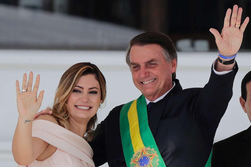 Michelle and Jair Bolsonaro wave to the crowds at his presidential inauguration