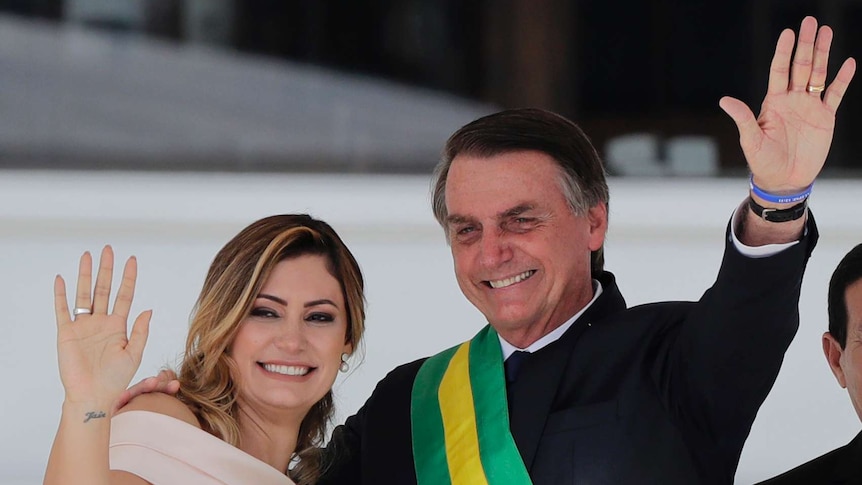 Michelle and Jair Bolsonaro wave to the crowds at his presidential inauguration