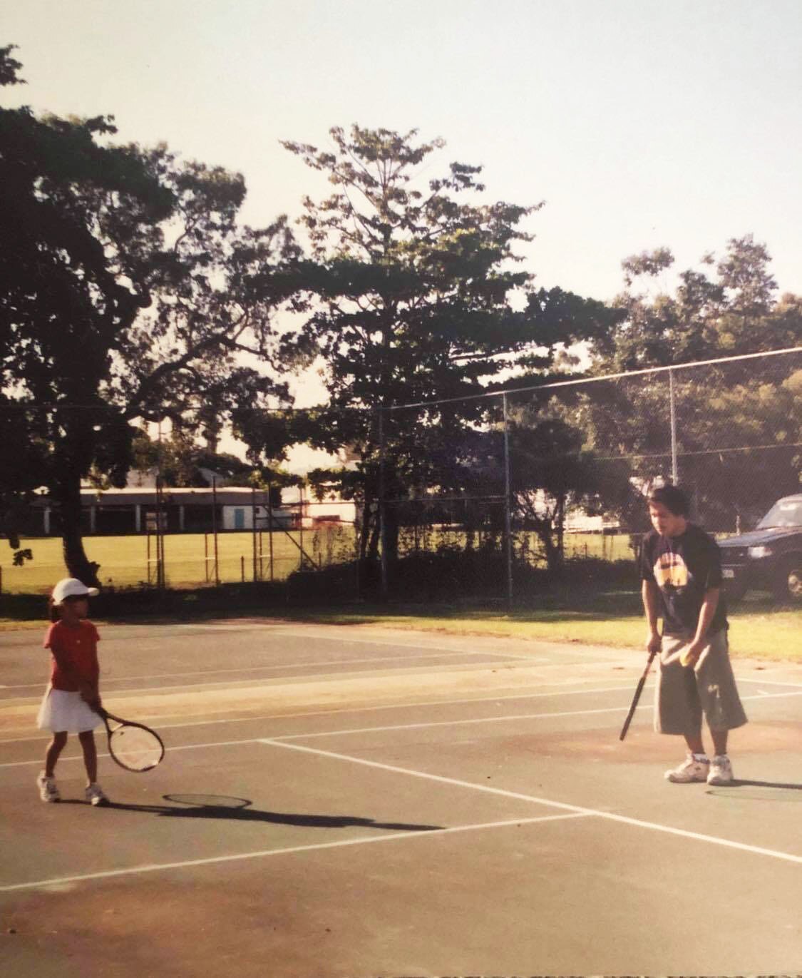 Lizette Cabrera, as a child, playing tennis with her father.