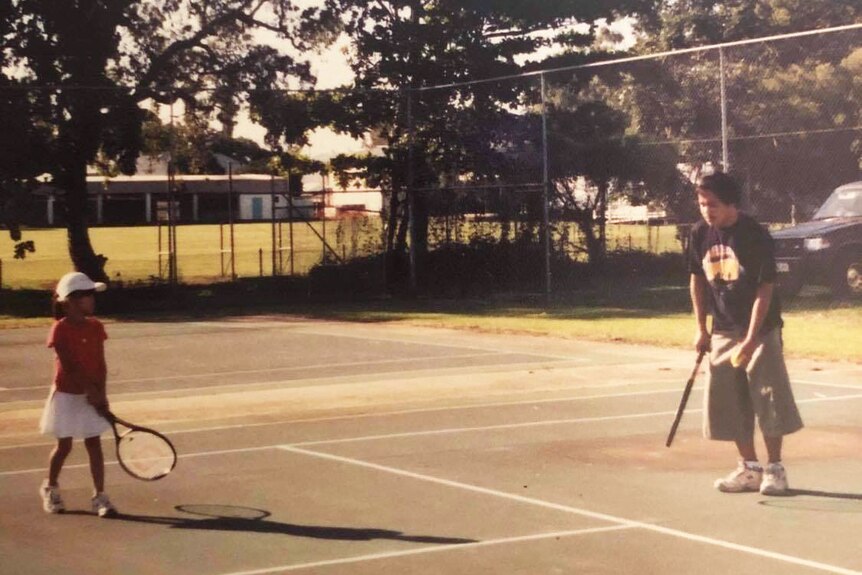 Lizette Cabrera as a child playing tennis with her dad.