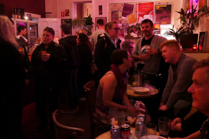 a group of people having a drink at the bar