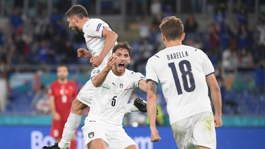 Three Italian players jump and celebrate