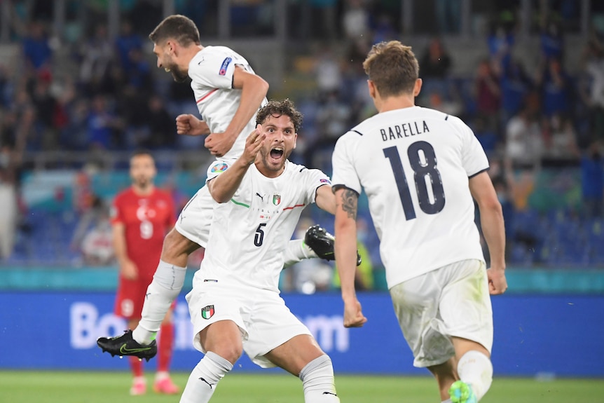 Three Italian players jump and celebrate