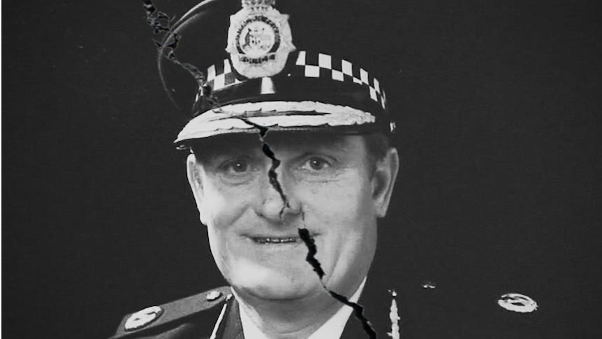 A crack runs down the middle of Colin Winchester's portrait in police uniform.