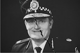 A crack runs down the middle of Colin Winchester's portrait in police uniform.