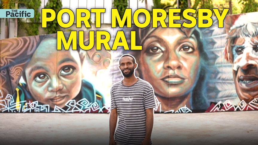 Man stands infront of colourful wall mural. Text reads 'Port Moresby Mural'. 