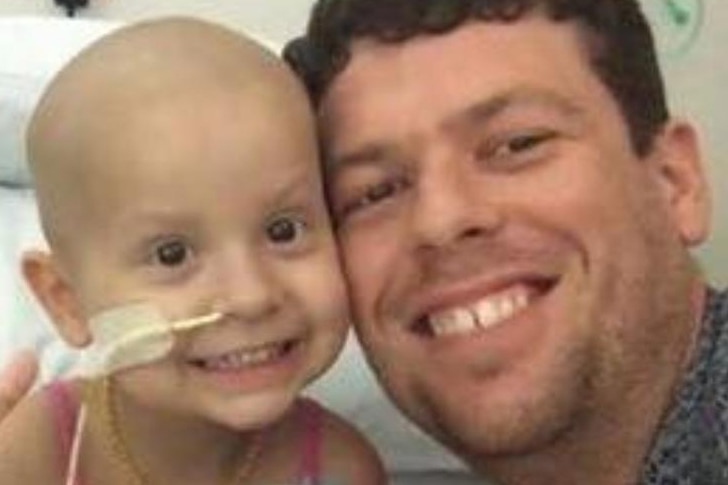 Adam Koessler with his daughter Rumer Rose, who was diagnosed a rare form of cancer in 2014.