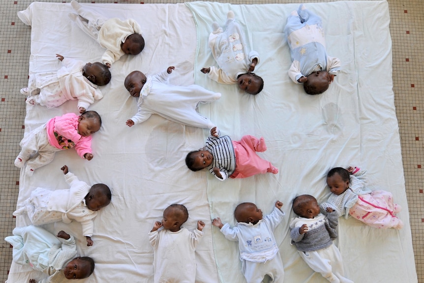 Babies rest on mat in Dakar, Senegal